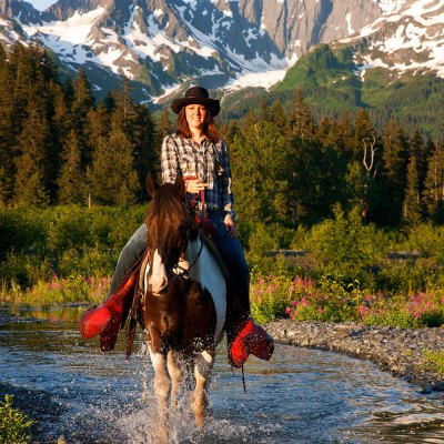 a man riding a horse in a river