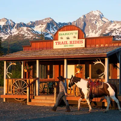 a close up of a horse drawn carriage in front of a mountain